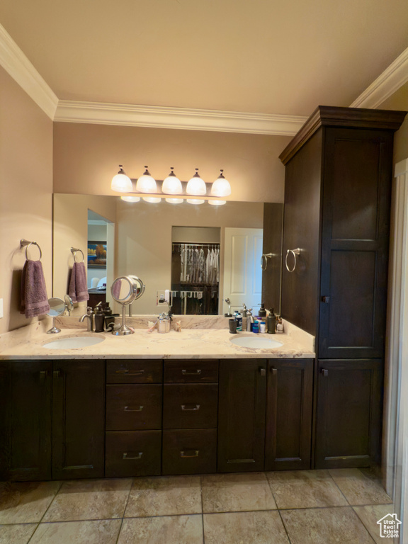 Full bathroom featuring crown molding and double vanity