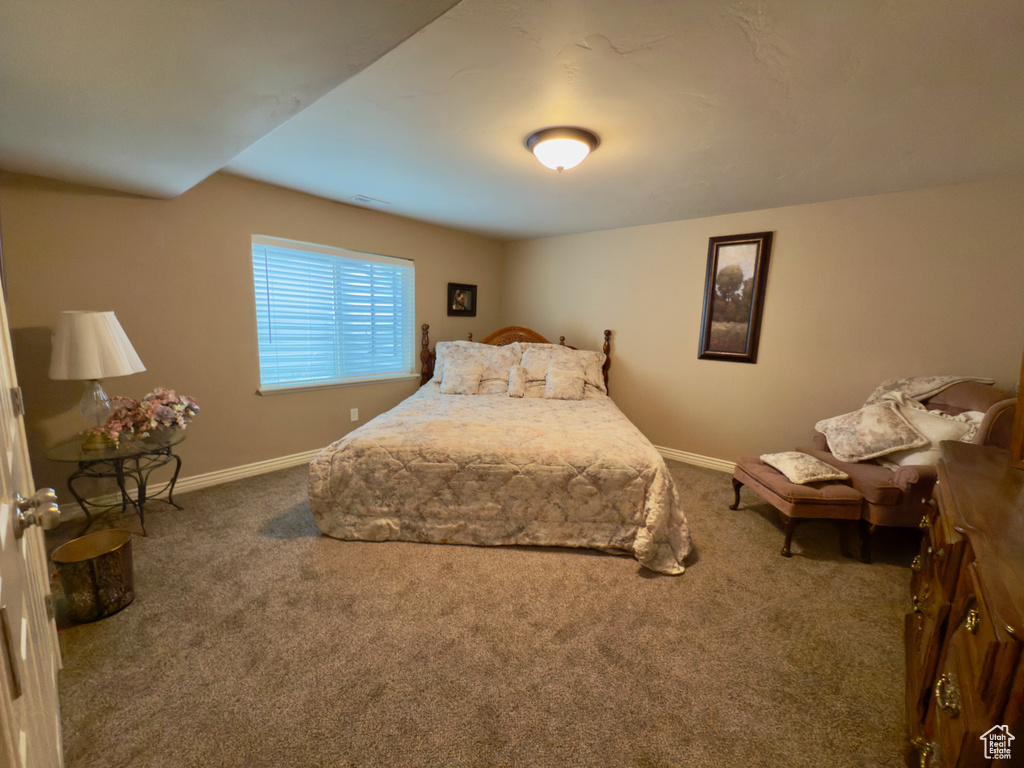 Carpeted bedroom featuring baseboards