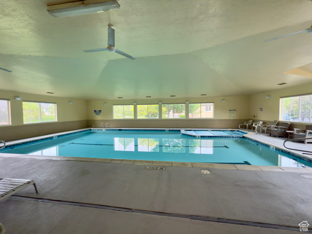 Indoor community pool featuring ceiling fan