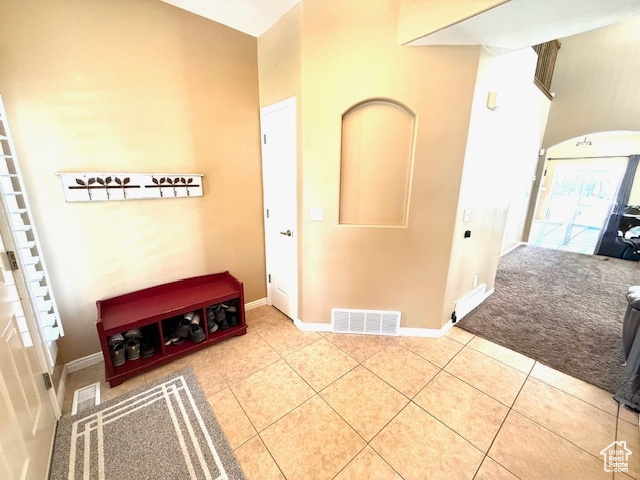 Tiled entryway featuring baseboards