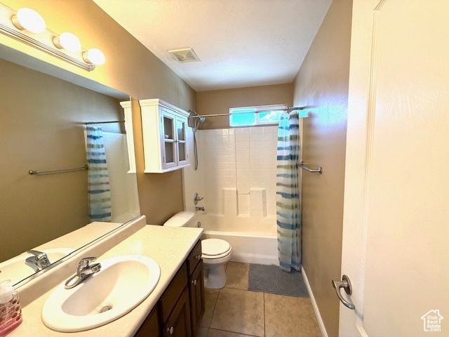 Bathroom with vanity, toilet, shower / bath combination with curtain, and tile patterned flooring