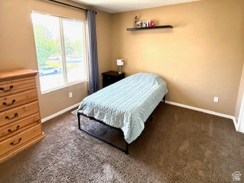 Carpeted bedroom featuring baseboards