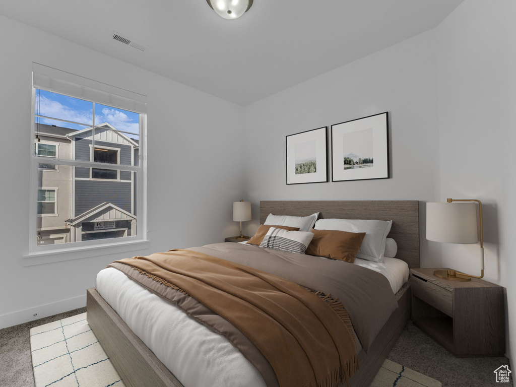 Carpeted bedroom featuring baseboards