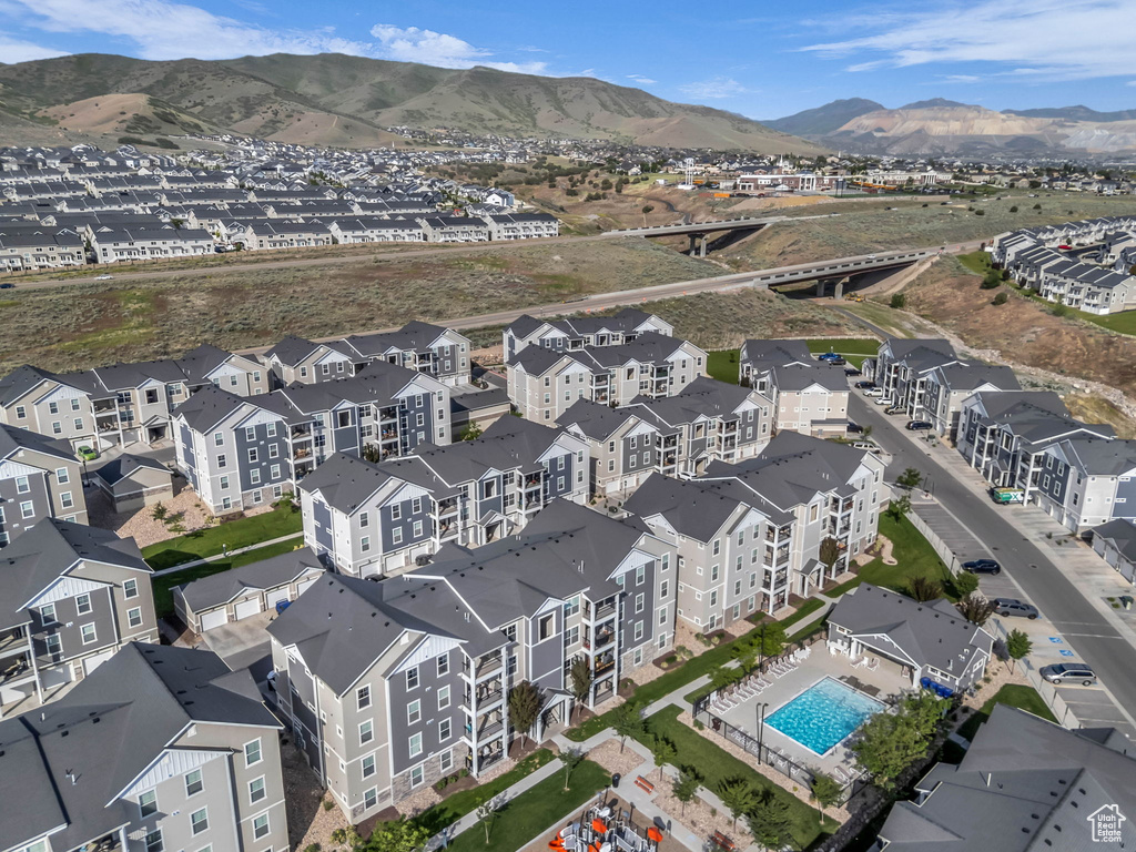 View of property location with a pool and a mountainous background