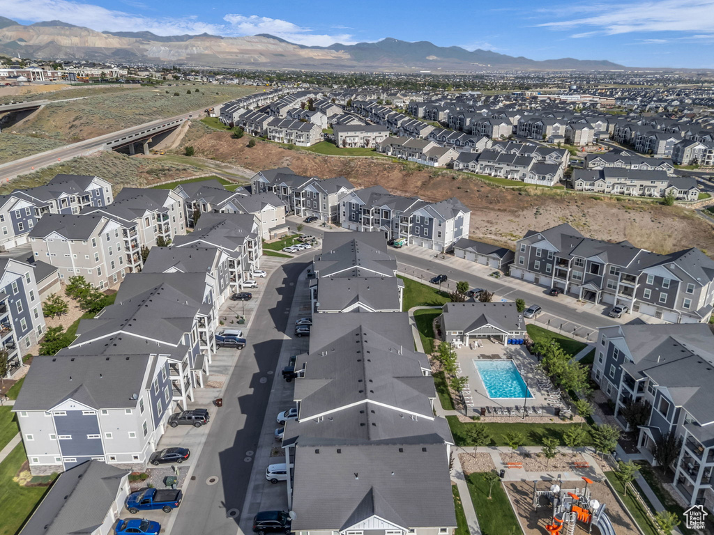 Aerial view of residential area with a pool and mountains