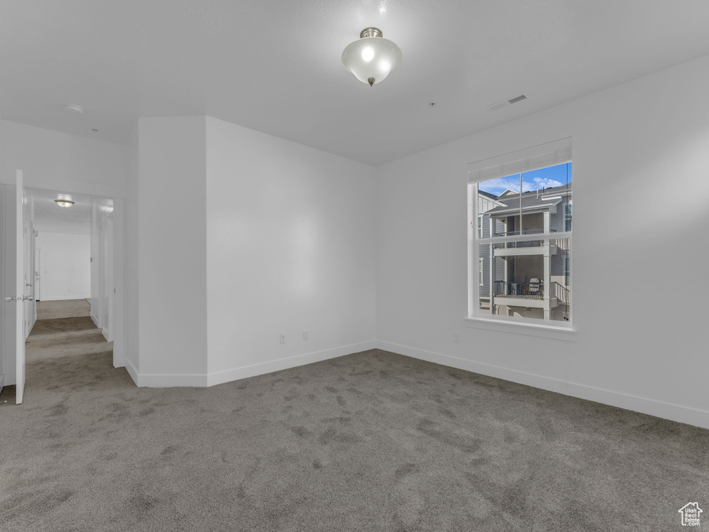Carpeted spare room with baseboards