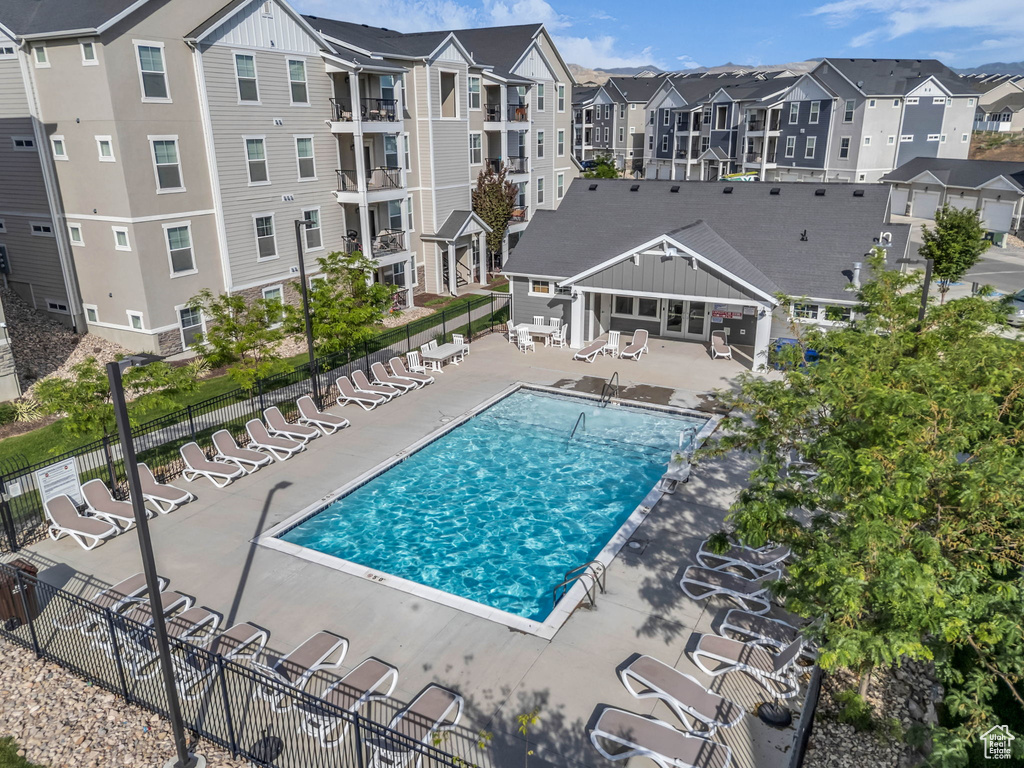 Community pool with a patio and a residential view