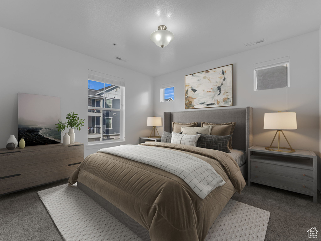 Bedroom with dark colored carpet