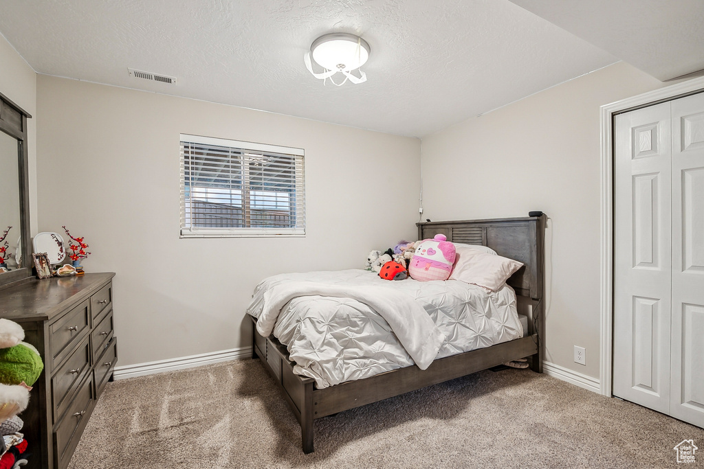 Carpeted bedroom with baseboards