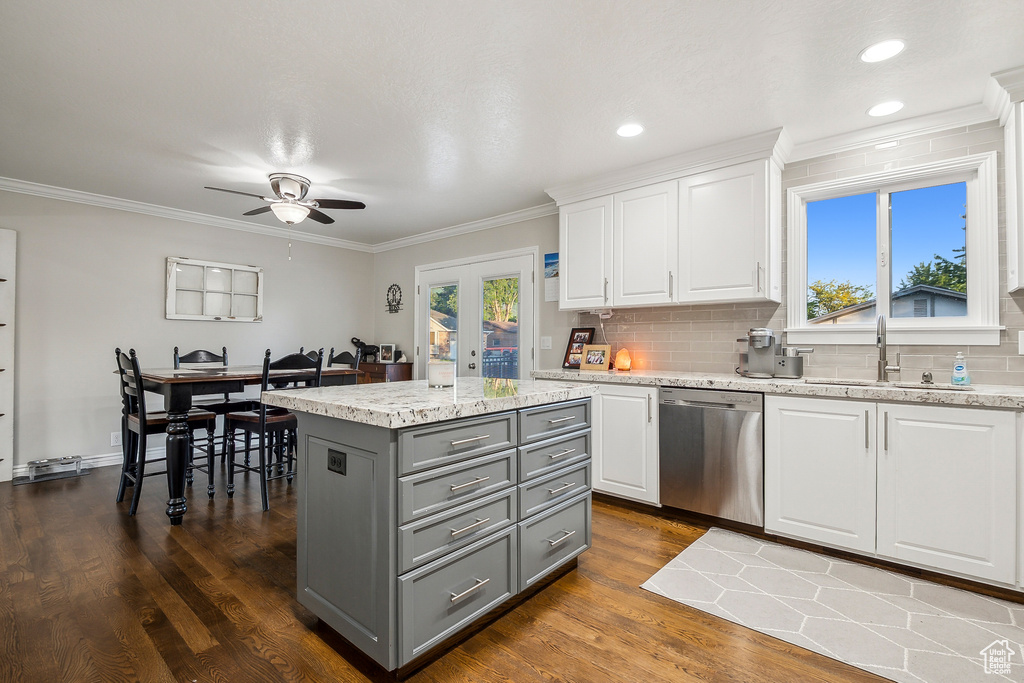 Kitchen featuring stainless steel dishwasher, gray cabinetry, a sink, white cabinetry, and a ceiling fan