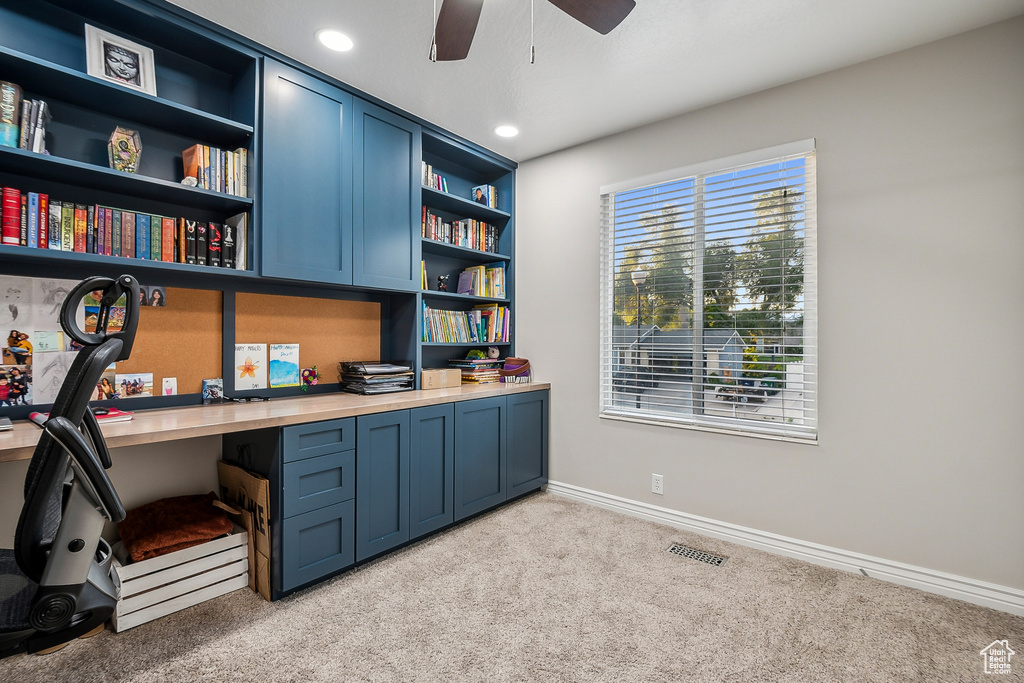 Home office featuring built in desk, light carpet, a ceiling fan, baseboards, and recessed lighting