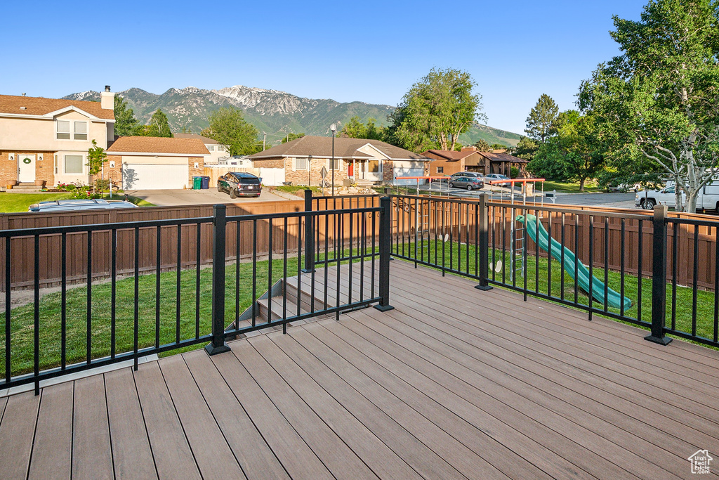 Wooden terrace with a residential view and a mountain view