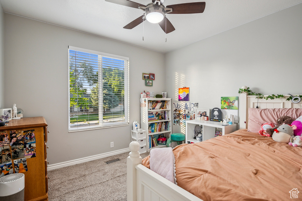 Carpeted bedroom featuring baseboards and ceiling fan