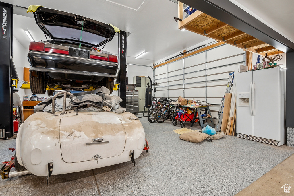 Garage with white fridge with ice dispenser