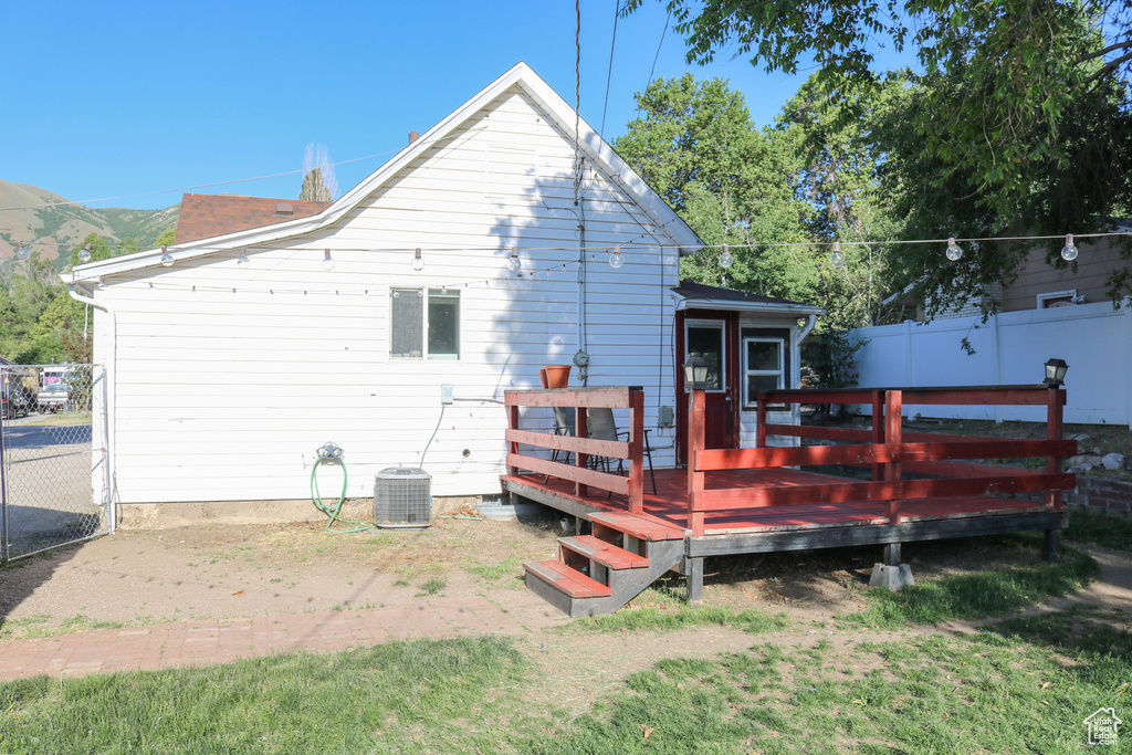 Rear view of house with a wooden deck and a chimney