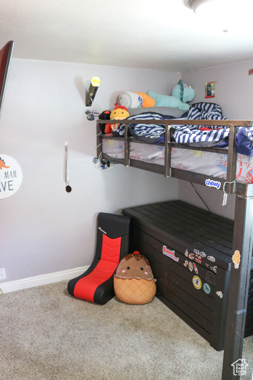 Bedroom featuring carpet floors and baseboards
