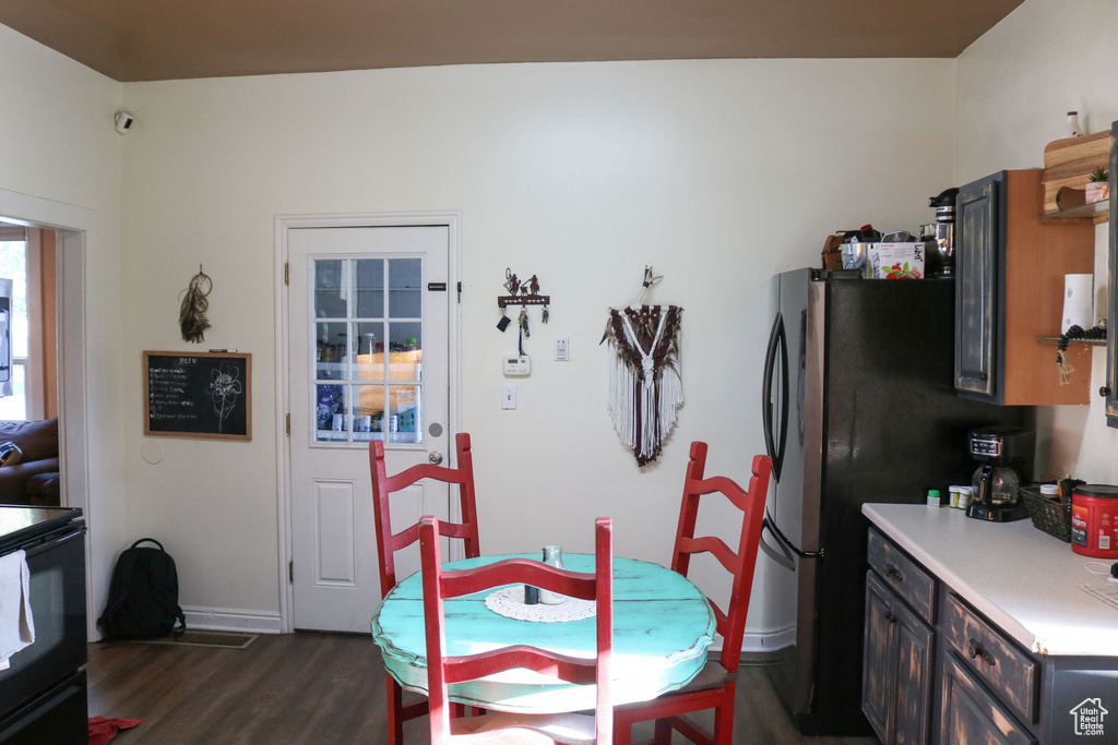Dining area featuring dark wood-style floors and baseboards