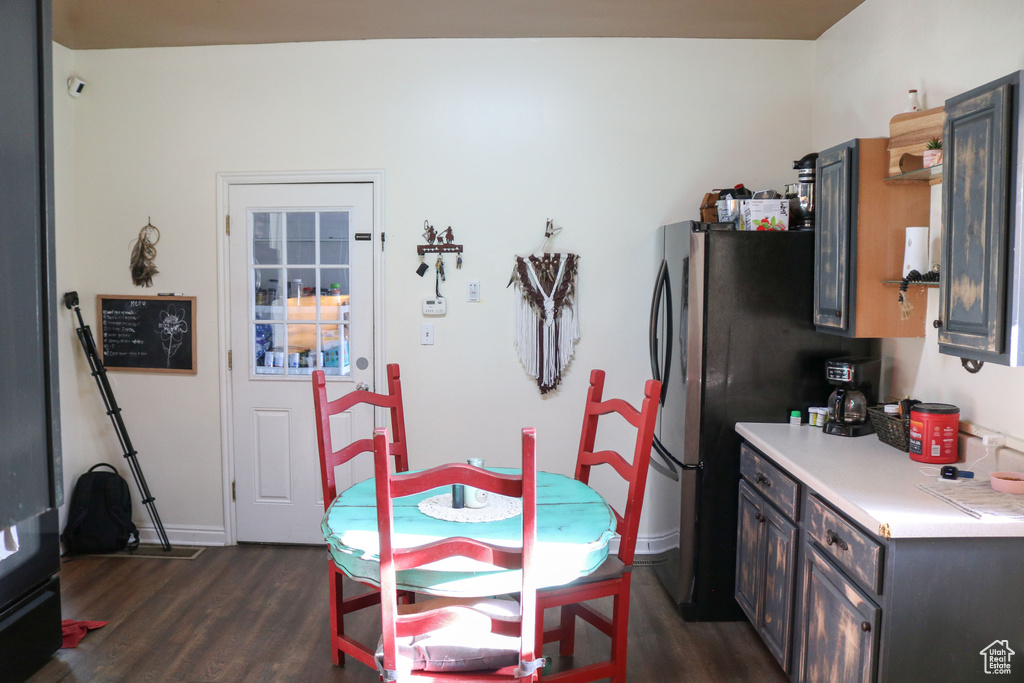 Dining area with dark wood finished floors and baseboards