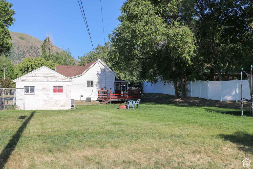View of yard with a deck with mountain view