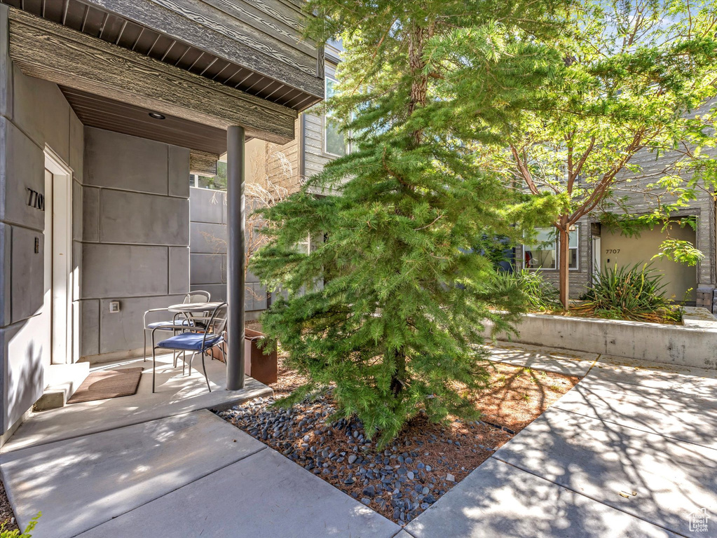 View of exterior entry with a patio area