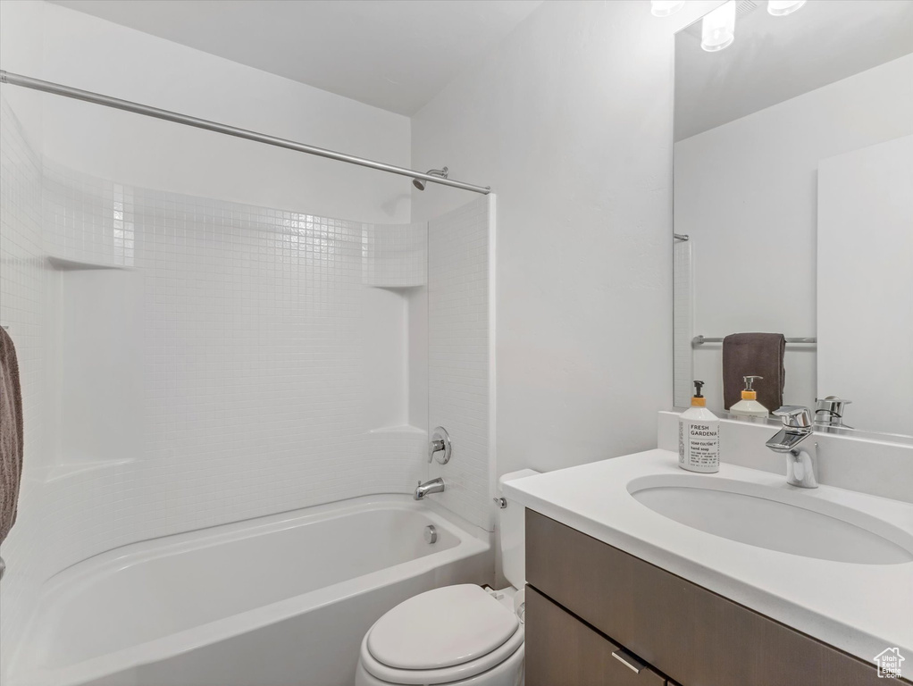 Full bathroom featuring vanity, bathtub / shower combination, and toilet