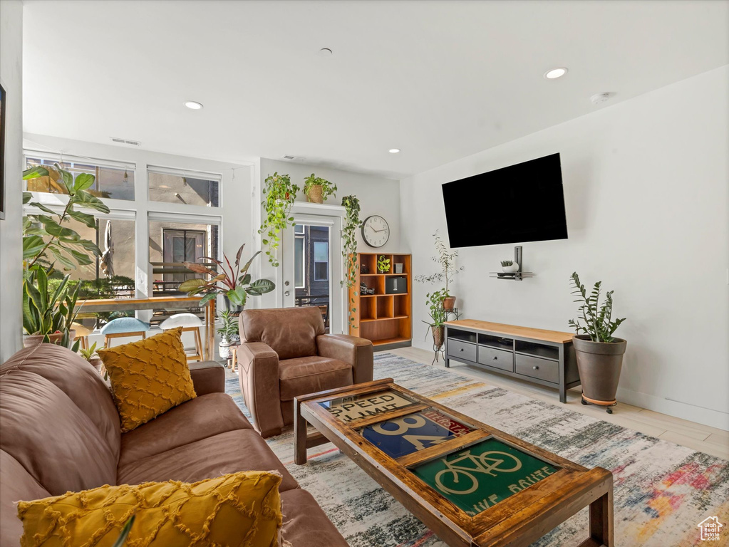 Living area featuring recessed lighting and light tile patterned floors