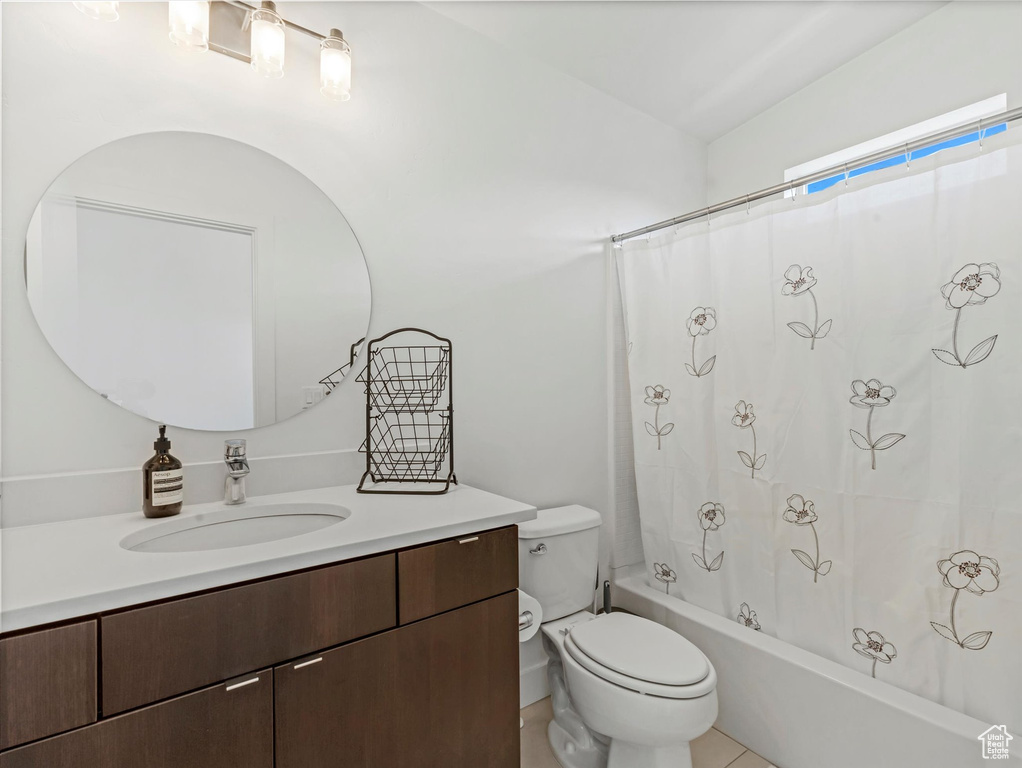 Full bath with vanity, toilet, and shower / bath combo