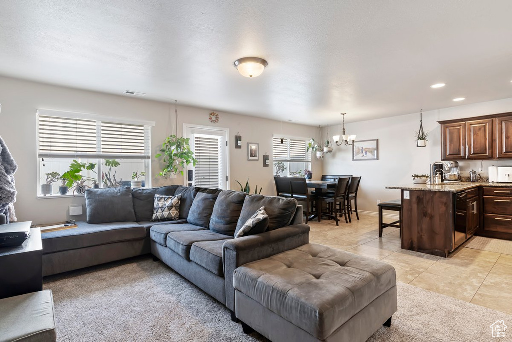 Living area featuring a chandelier, light tile patterned floors, and recessed lighting