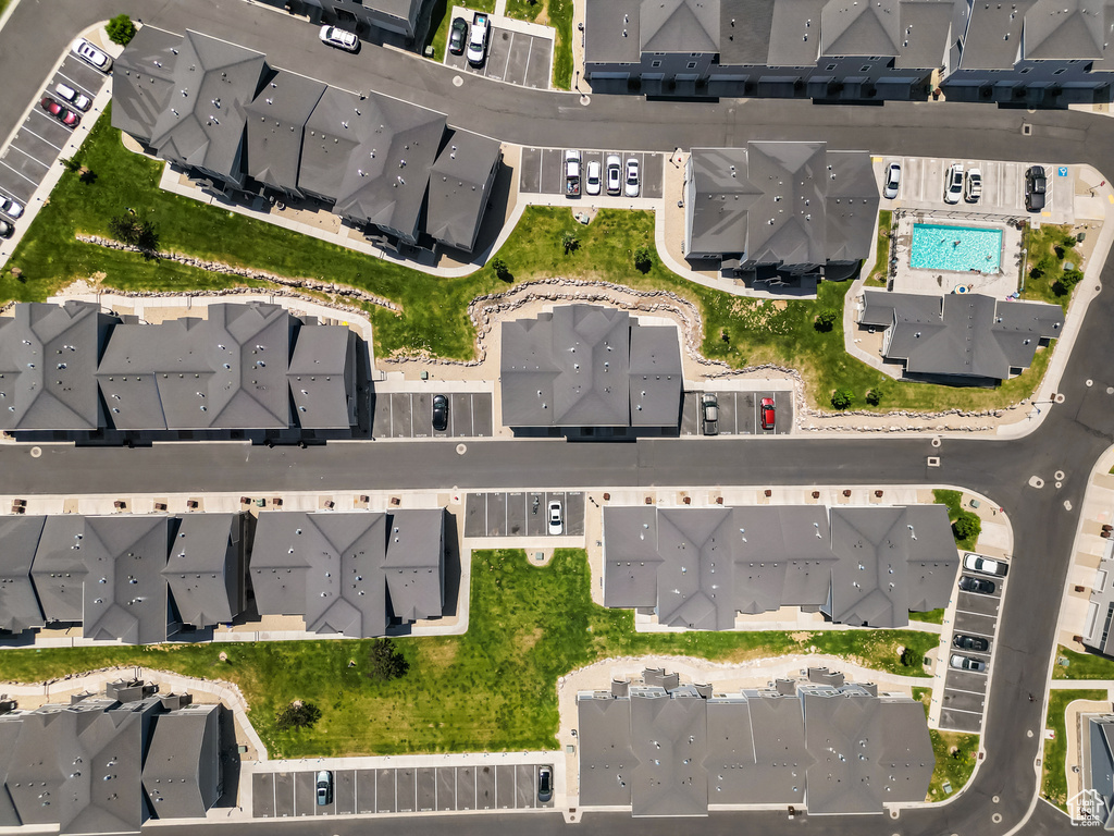 Aerial view of property and surrounding area with nearby suburban area and a pool