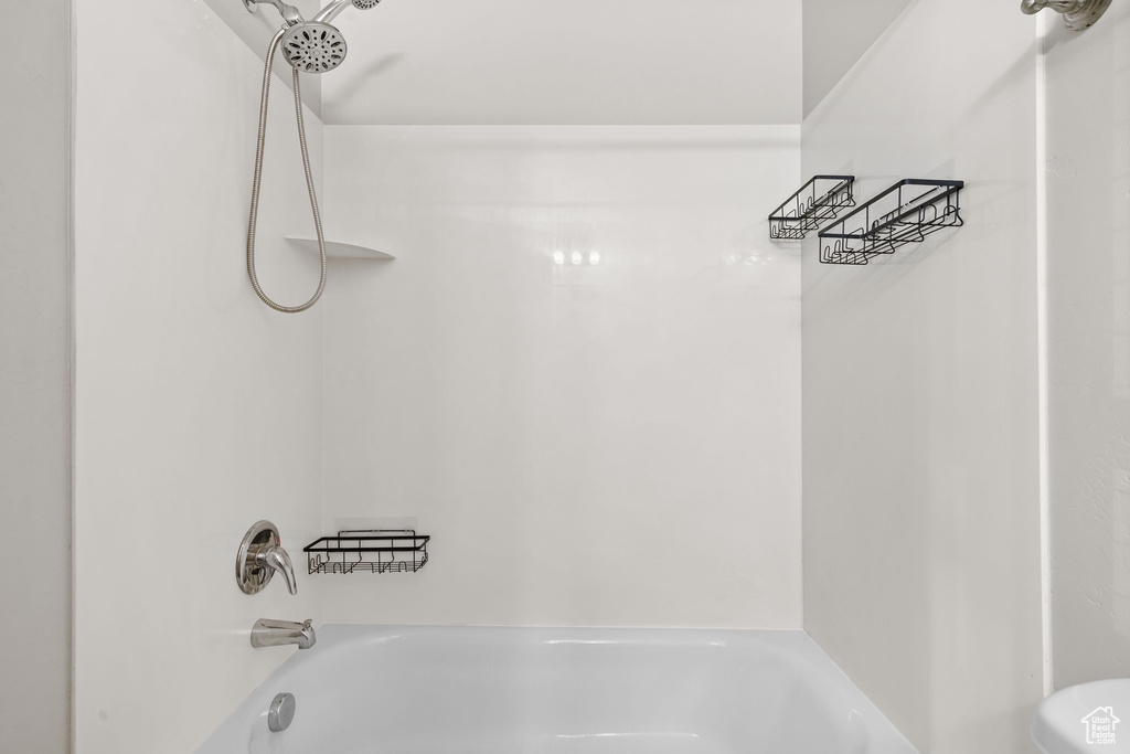 Bathroom with shower / washtub combination and toilet