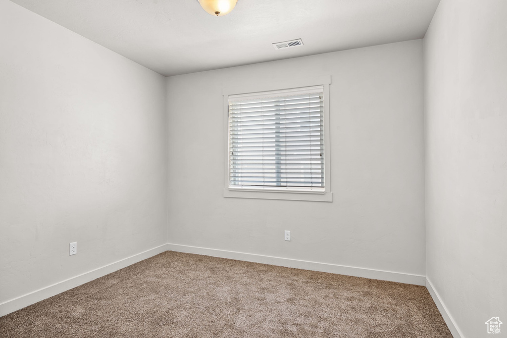 Empty room with carpet floors and baseboards