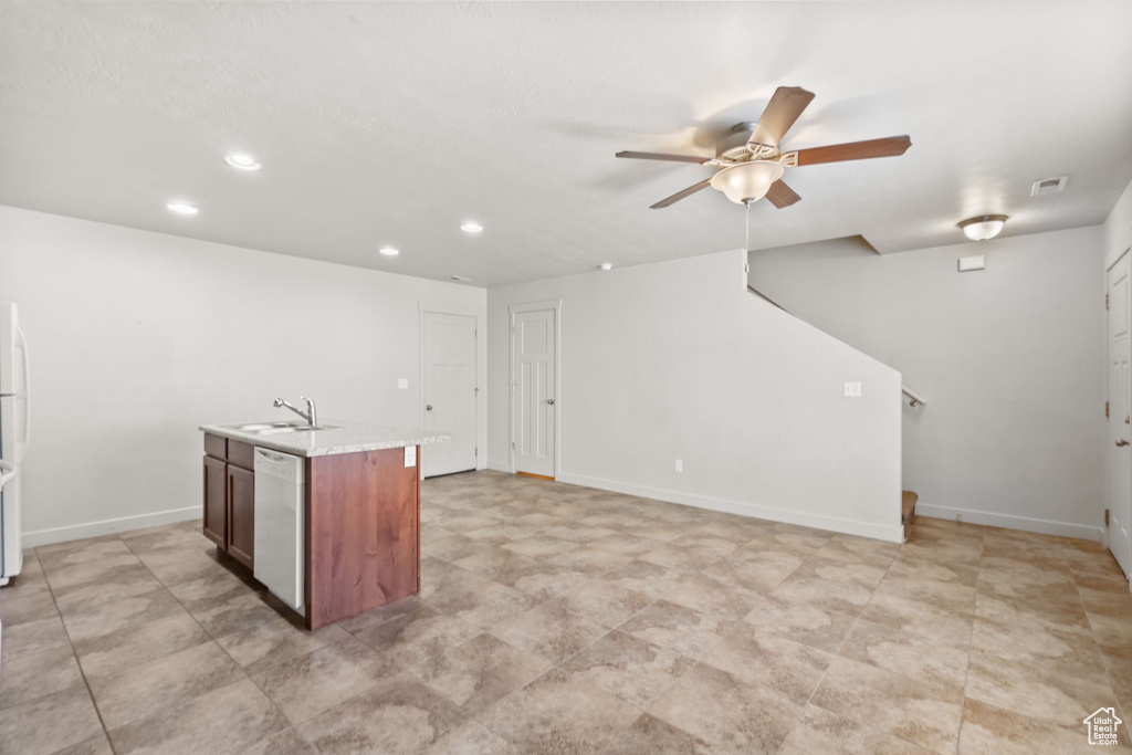 Kitchen featuring dishwasher, a sink, ceiling fan, recessed lighting, and a center island with sink