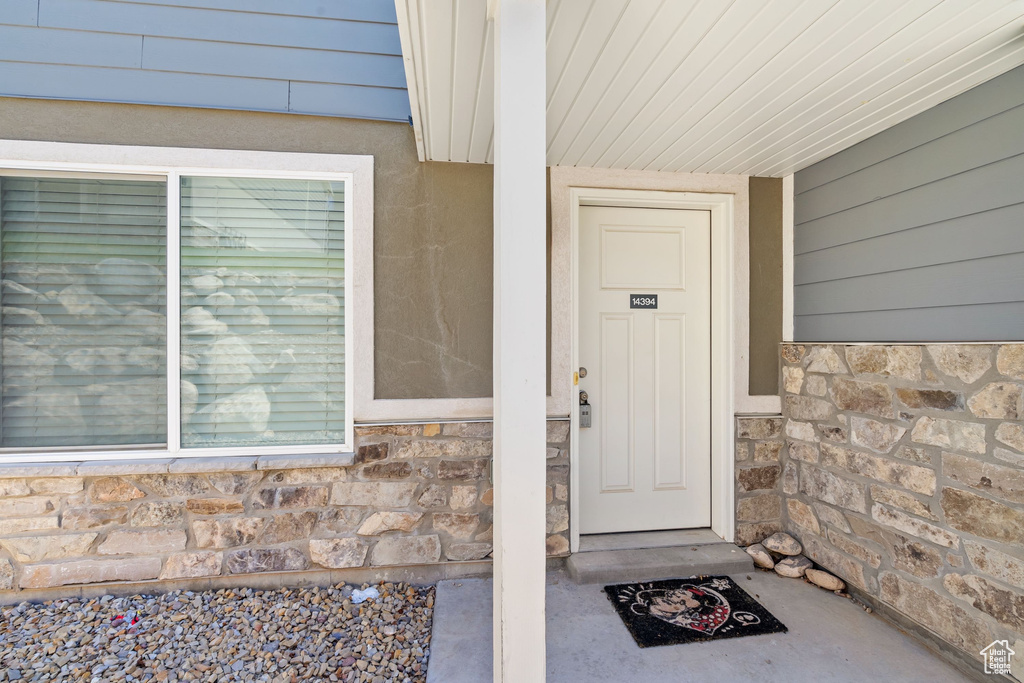 Entrance to property with stone siding