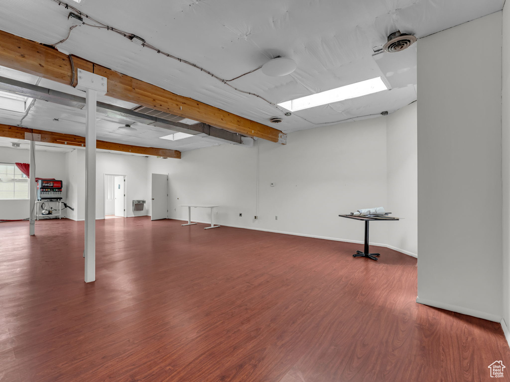 Basement featuring wood finished floors and baseboards
