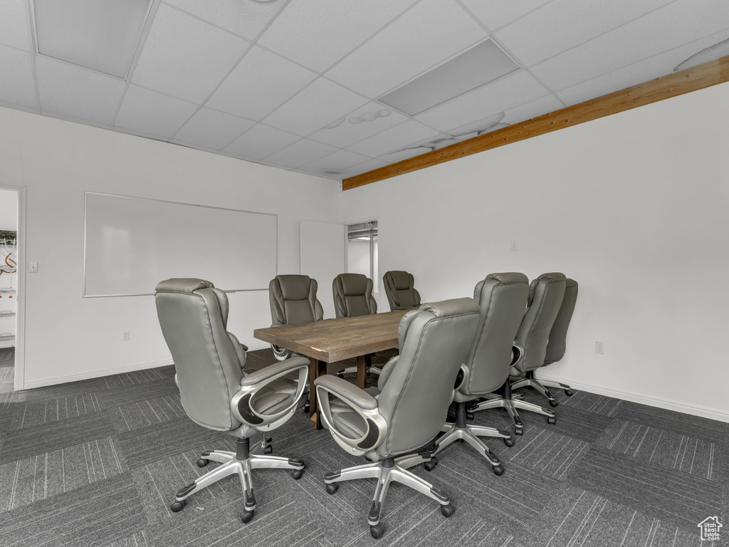 Carpeted home office featuring baseboards and a drop ceiling