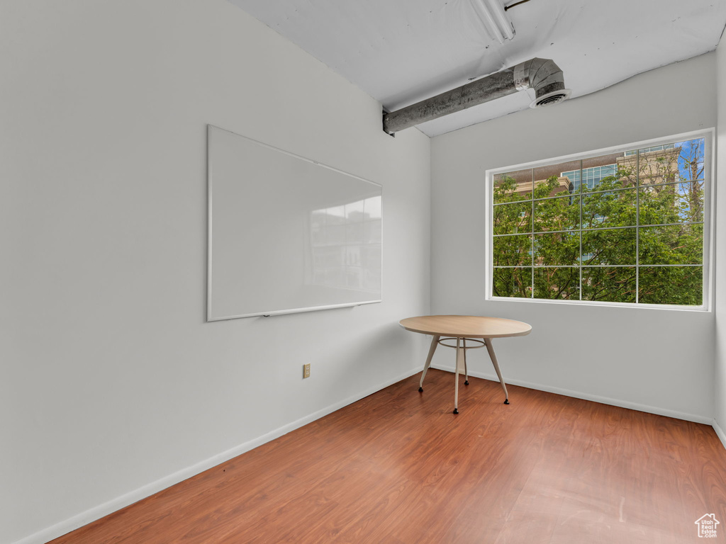 Unfurnished room featuring wood finished floors and baseboards