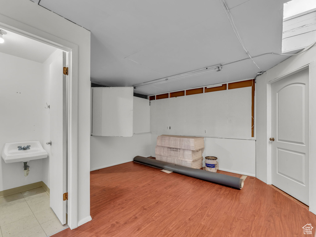 Finished below grade area with baseboards and wood finished floors