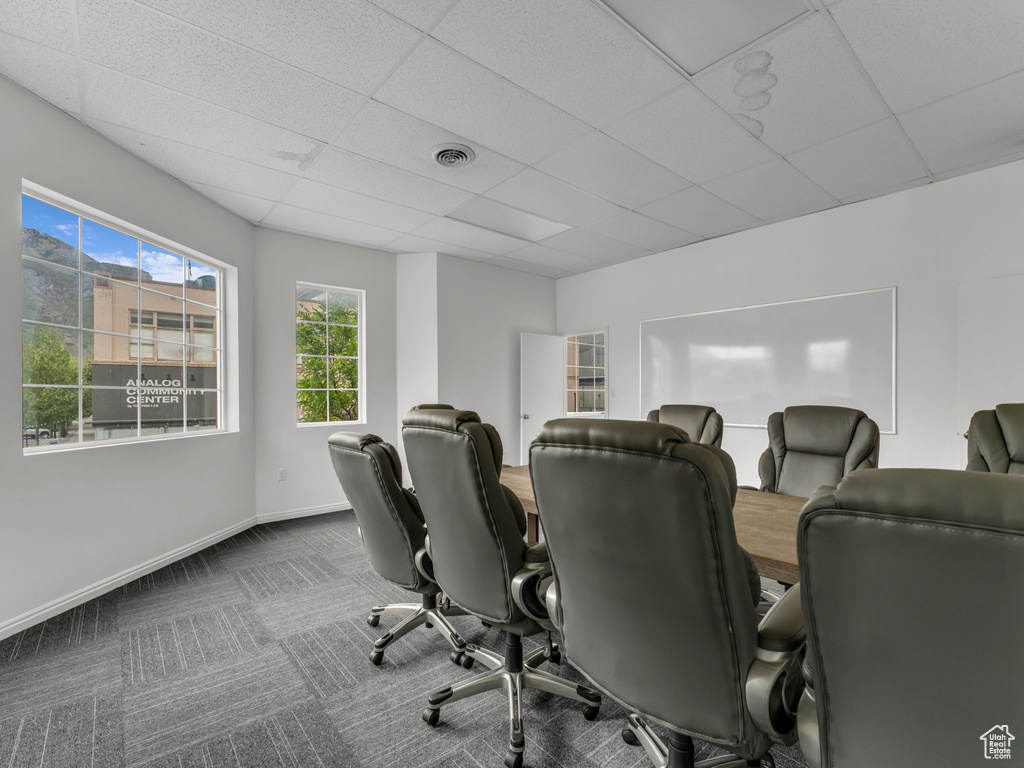 Office with a paneled ceiling, baseboards, and carpet