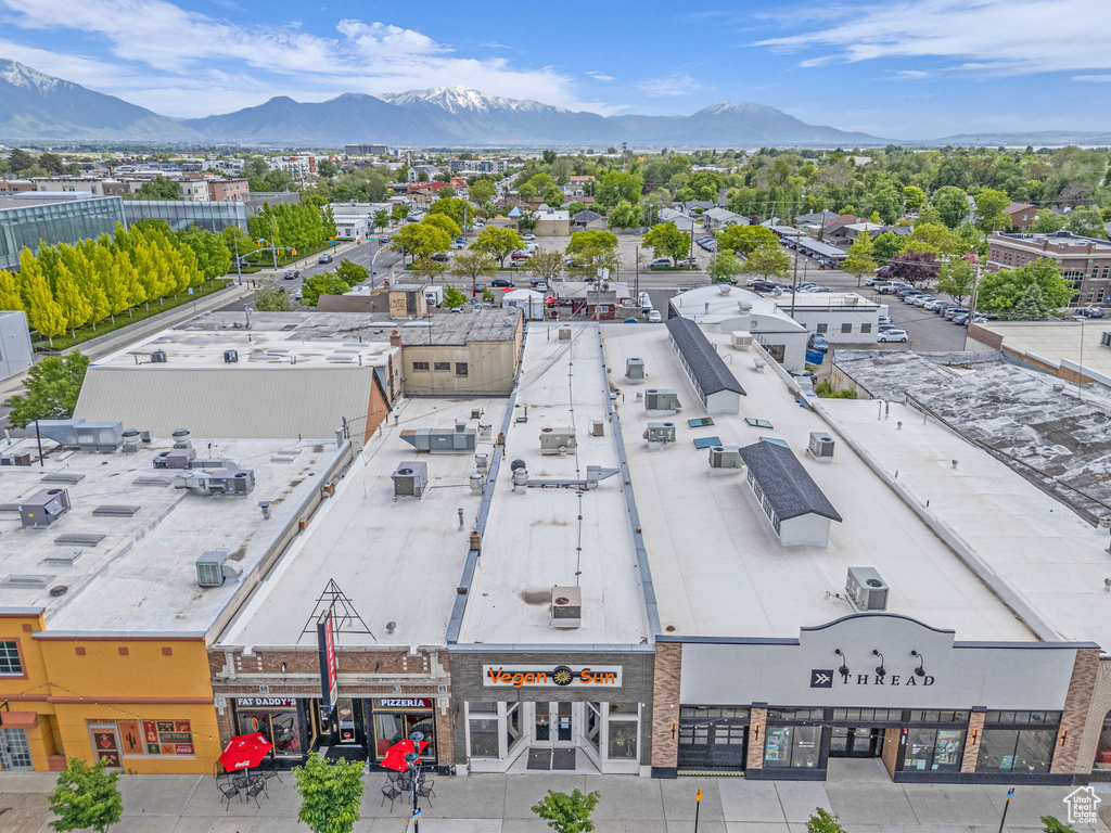 Drone / aerial view of a commercial area and a mountain backdrop
