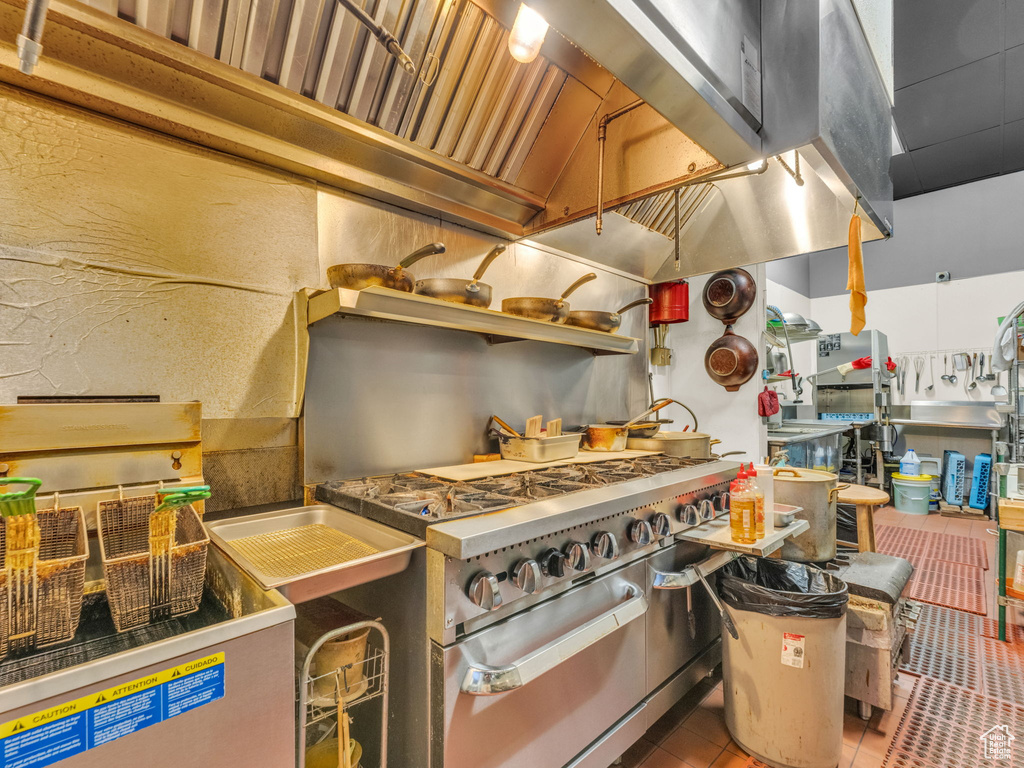 Kitchen featuring double oven range and tile patterned flooring