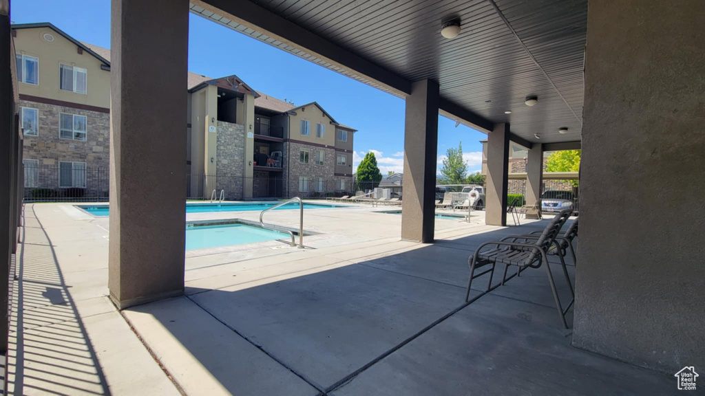 Community pool with a patio and a residential view