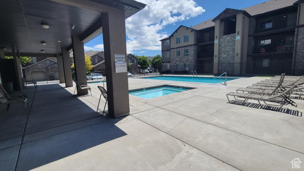 Community pool with a community hot tub and a patio