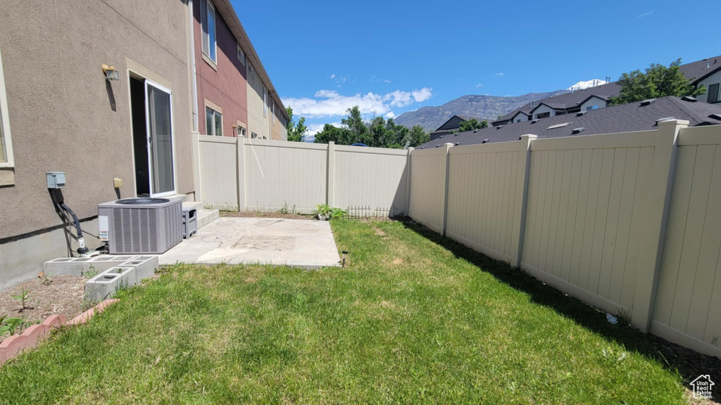 View of yard featuring central AC, a patio area, and a mountain view
