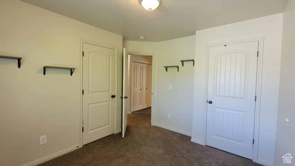 Unfurnished bedroom with carpet floors, baseboards, and a closet