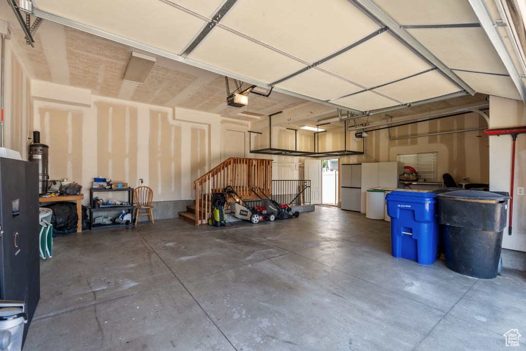 Garage with a garage door opener and fridge
