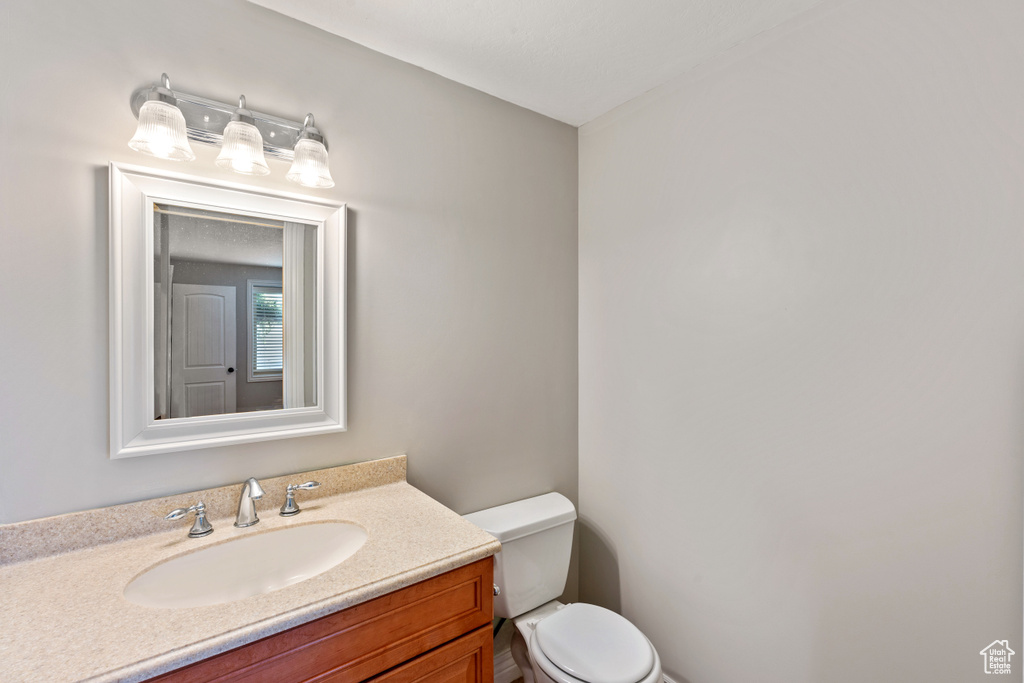 Half bathroom featuring toilet and vanity