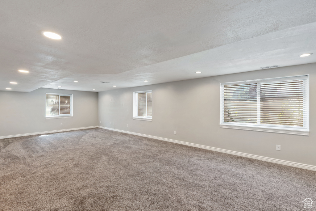 Empty room with recessed lighting, carpet, and baseboards
