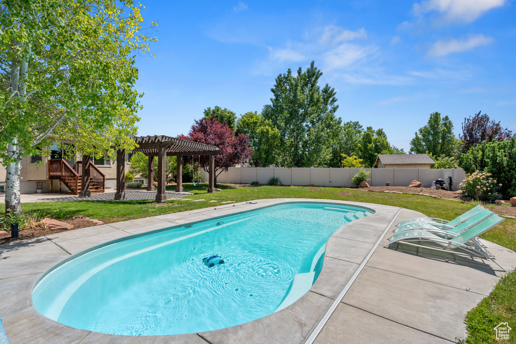 View of swimming pool with a pergola and a patio area