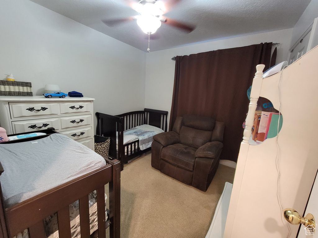 Bedroom featuring light colored carpet and ceiling fan