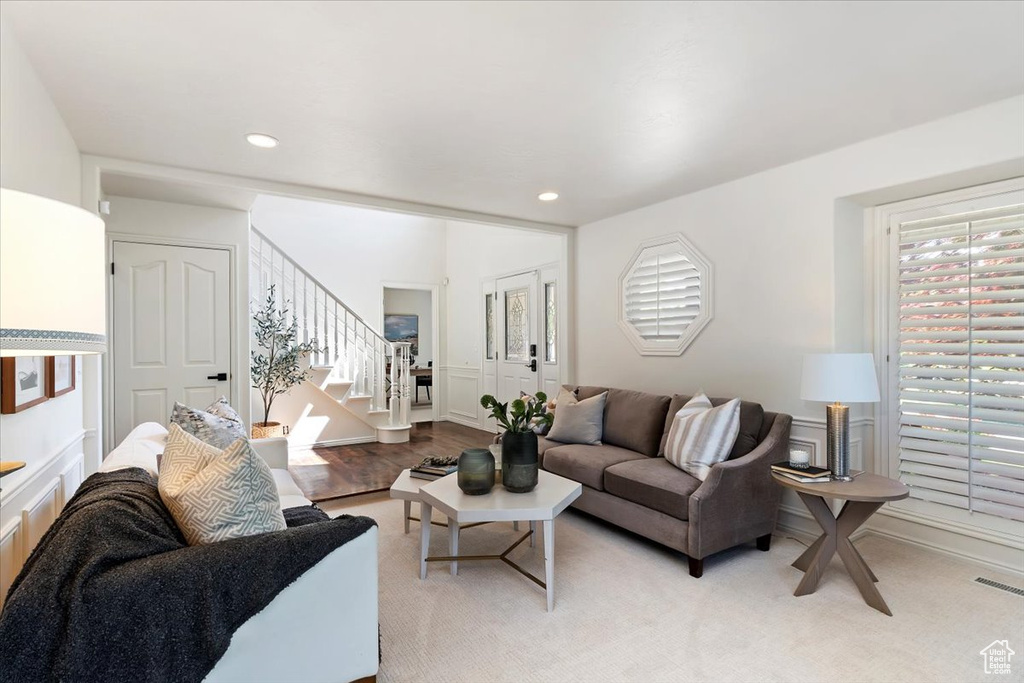 Living room with stairway and recessed lighting